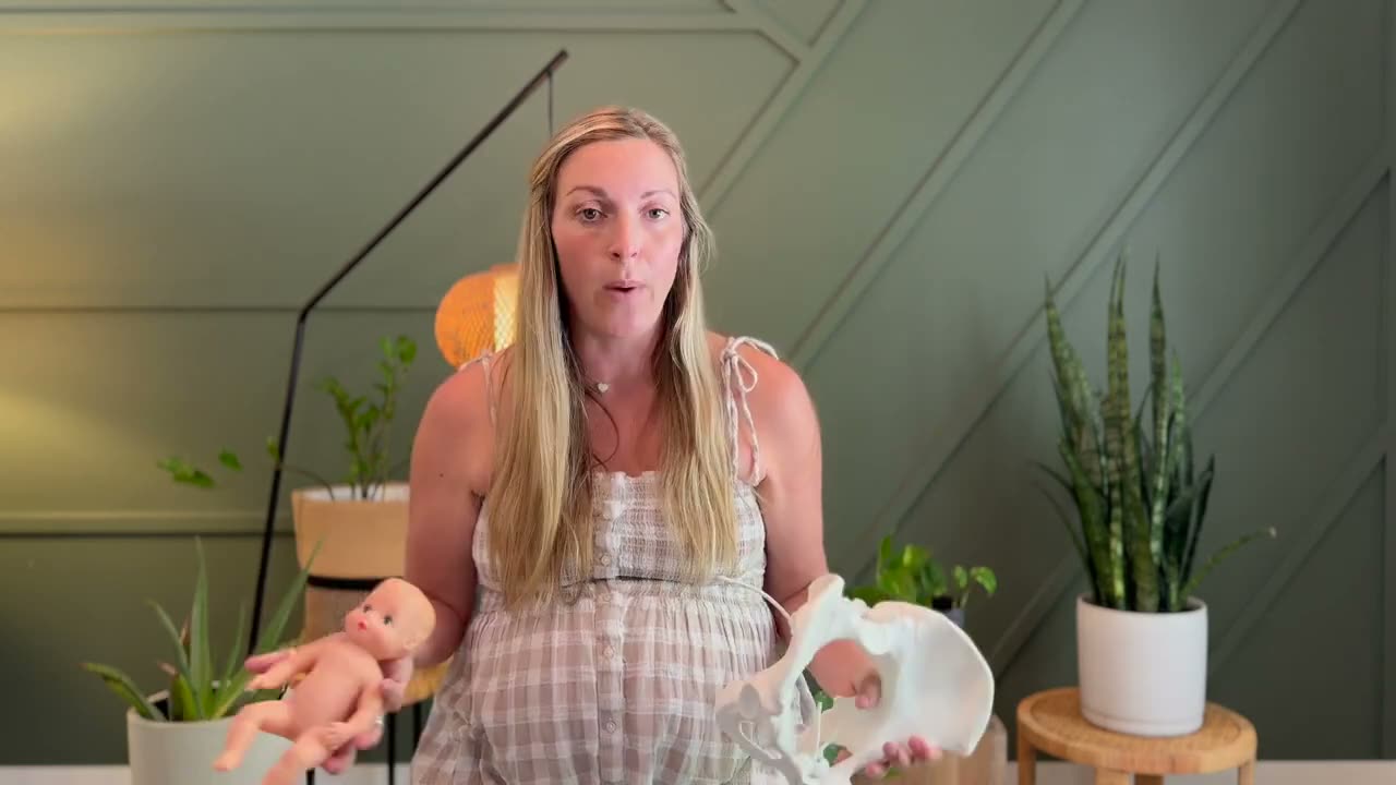 Hailey teaching with a pelvis model and a baby doll